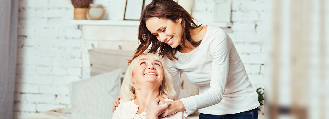 caregiver hugging her client indoor